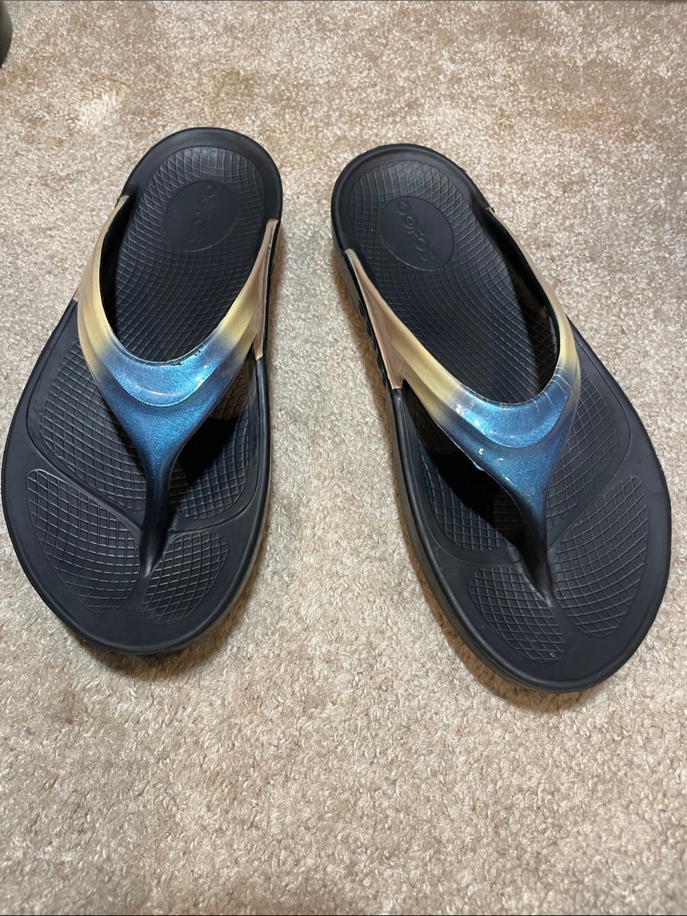OOFOS Black Flip Flops with Blue-to-Gold Gradient Straps
